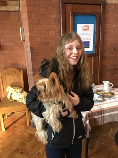 Mae Valle, an 18 year old girl, holding a small dog